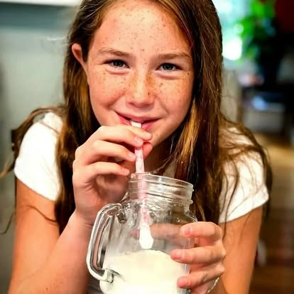 Girl drinking flavored milk with Magic Straw